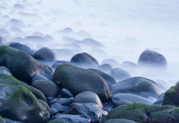 Wet round rocks covered by mist